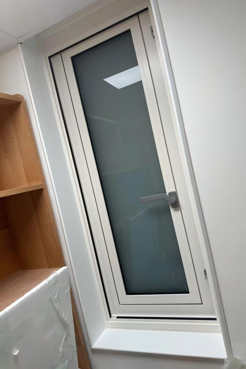 White powder-coated aluminum interior window casing (NCT) installed on a bright interior wall